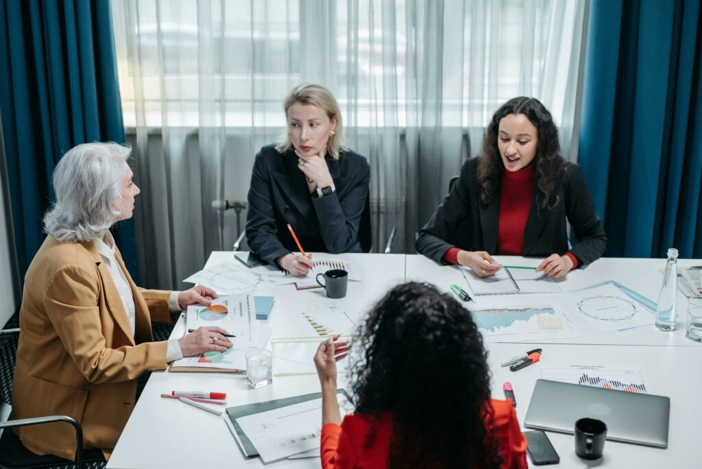 Four businesswomen collaborating around a table, representing women-owned business