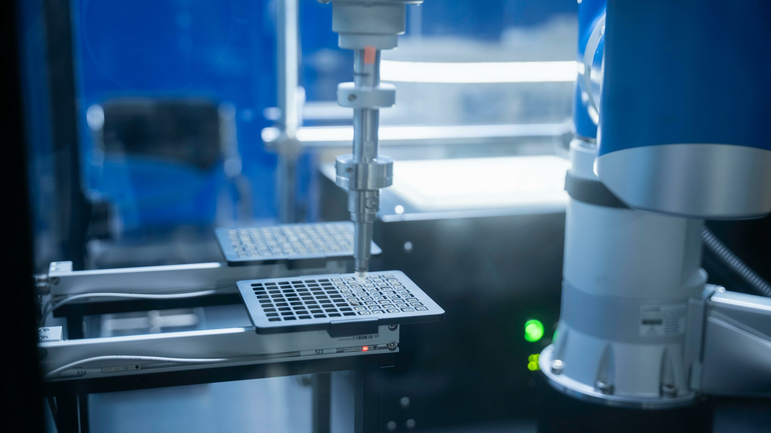 Engineer integrating machine systems and workflows on a manufacturing line, representing implementation and integration services
